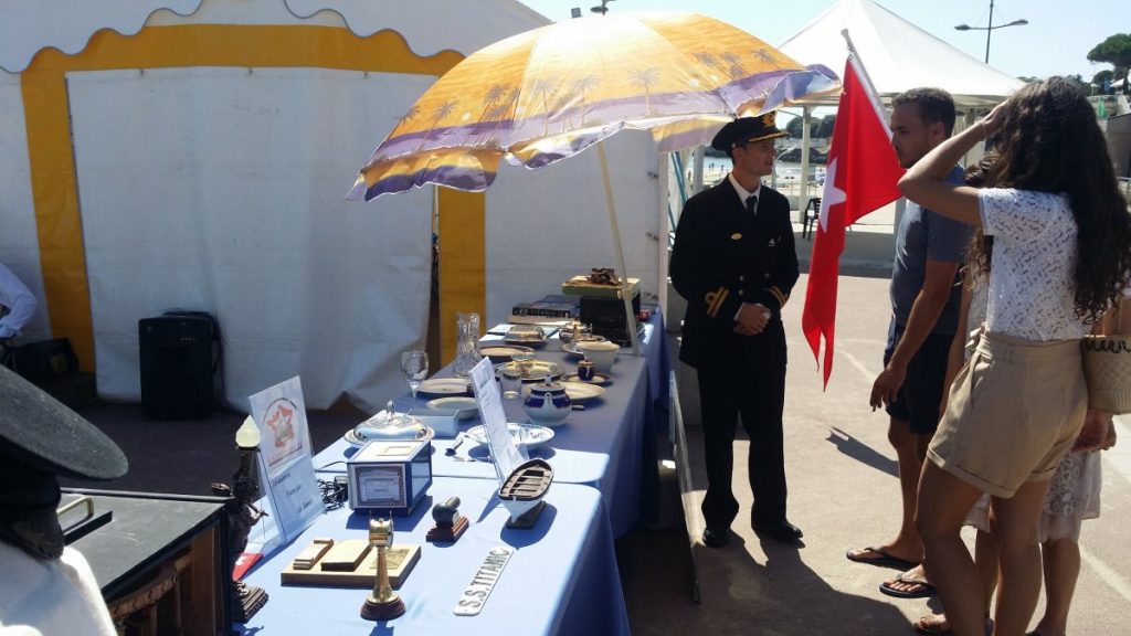 Un homme habillé en officier présente son stand.