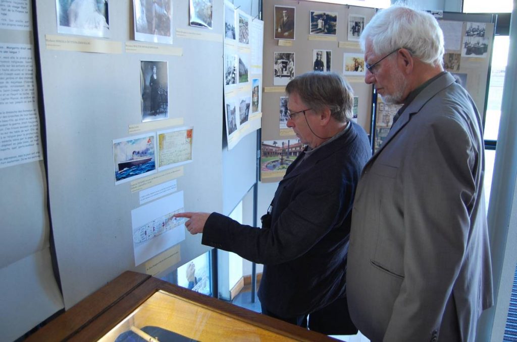 Deux hommes discutent devant un plan.