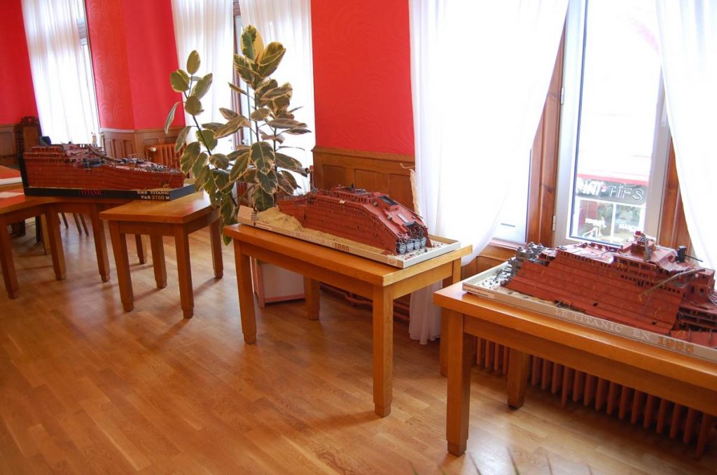 Trois maquettes de l'épave sur des tables.